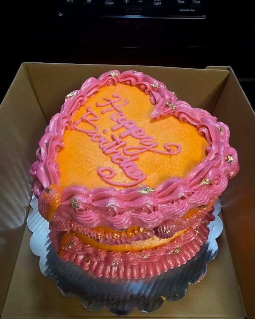 Velvet Wing heart shaped birthday cake with bright pink and orange vintage piping